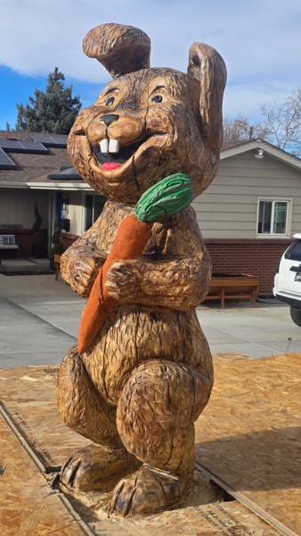Chainsaw carved wooden rabbit sculpture angle view